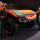 A photo of Emma Gilmour and Tanner Foust with the McLaren Odyssey 21 car.